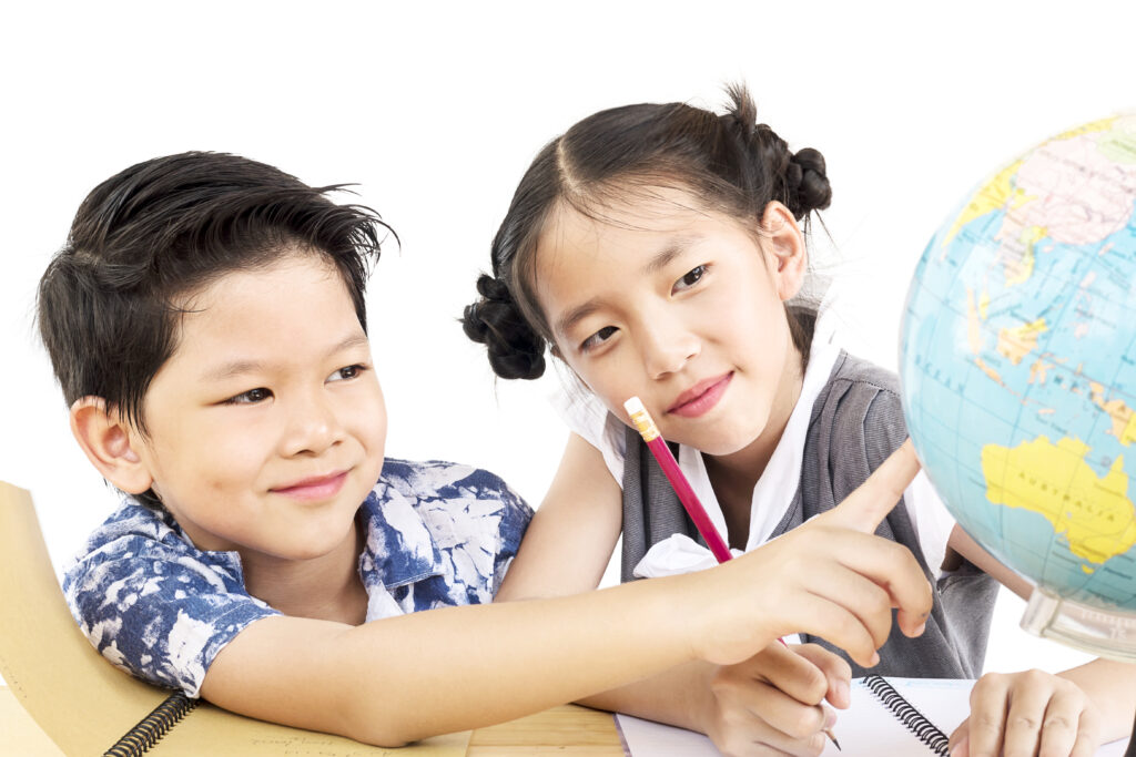 Asian kids are studying the globe over white background